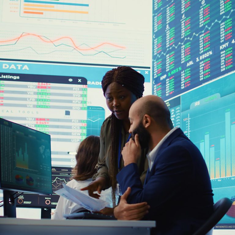 Diverse business analysts working together to evaluate costs and create a projection to deduct the future enterprise situation. Financial advisers specialists studying budget numbers. Camera B.